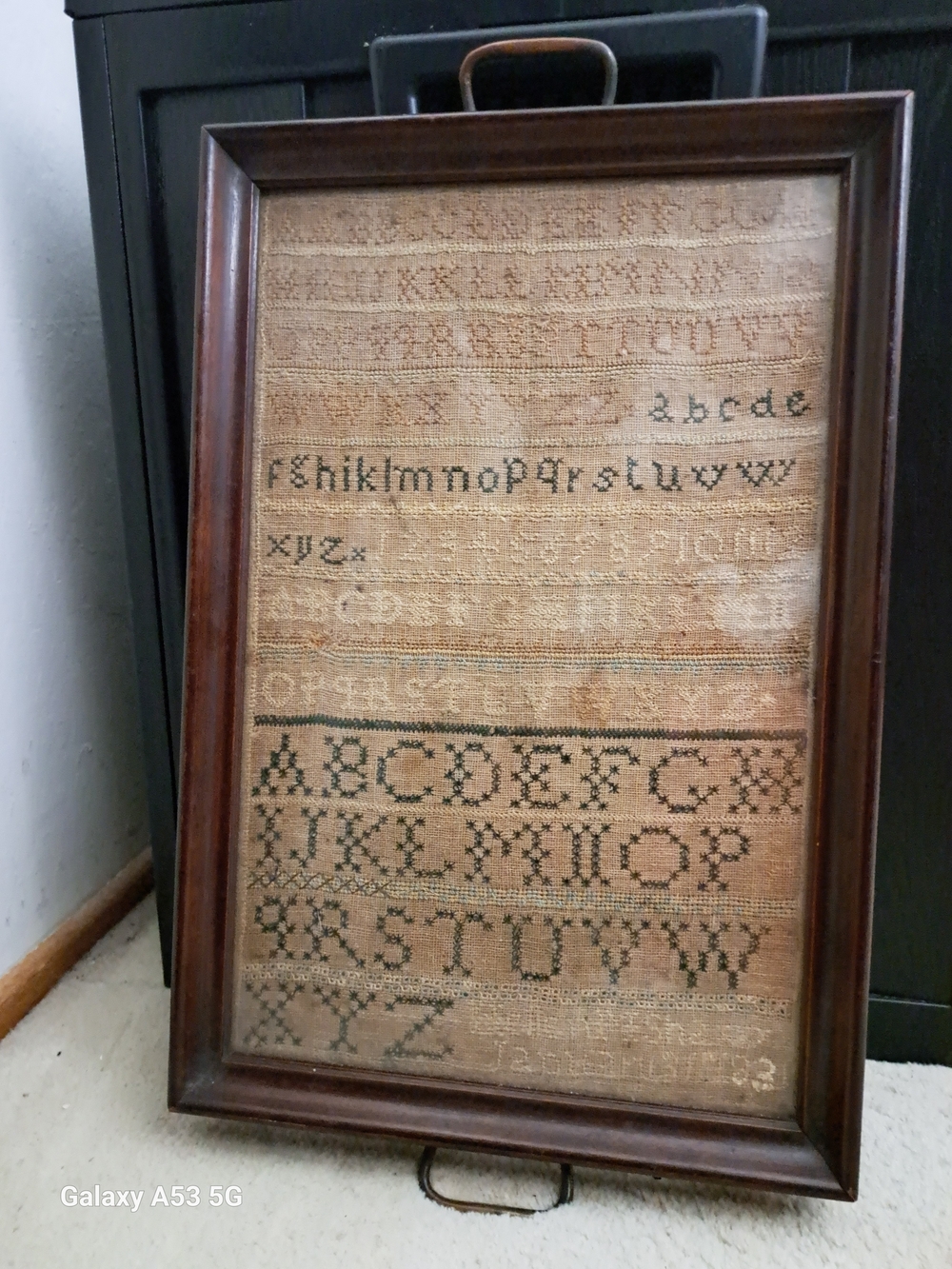 Antique framed hand-stitched alphabet and number needlework sampler